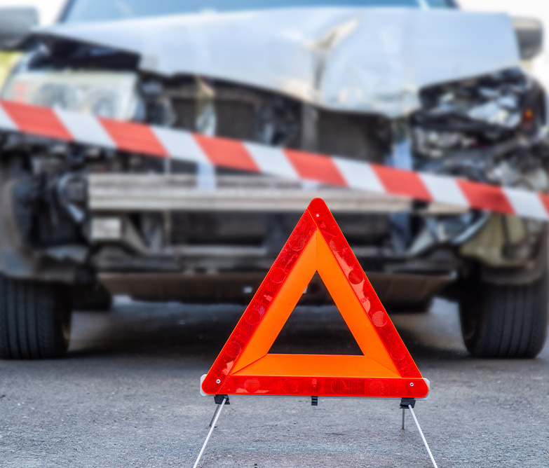 Unfall als Geschädigter – Unfallfahrzeug mit Warndreieck und Absperrband